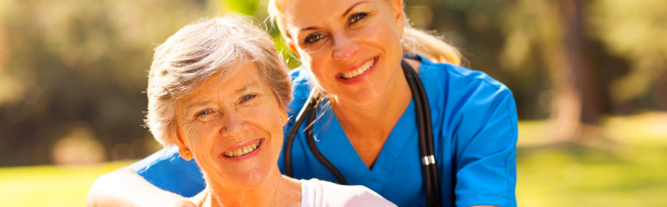a smiling senior woman with her caregiver
